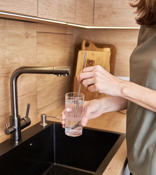 woman getting clean water from sink