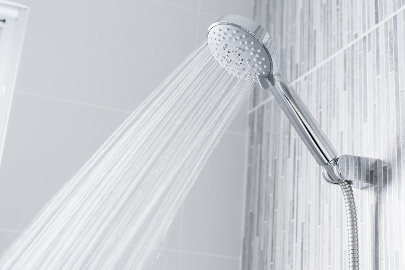 Bathroom shower head spraying conditioned water
